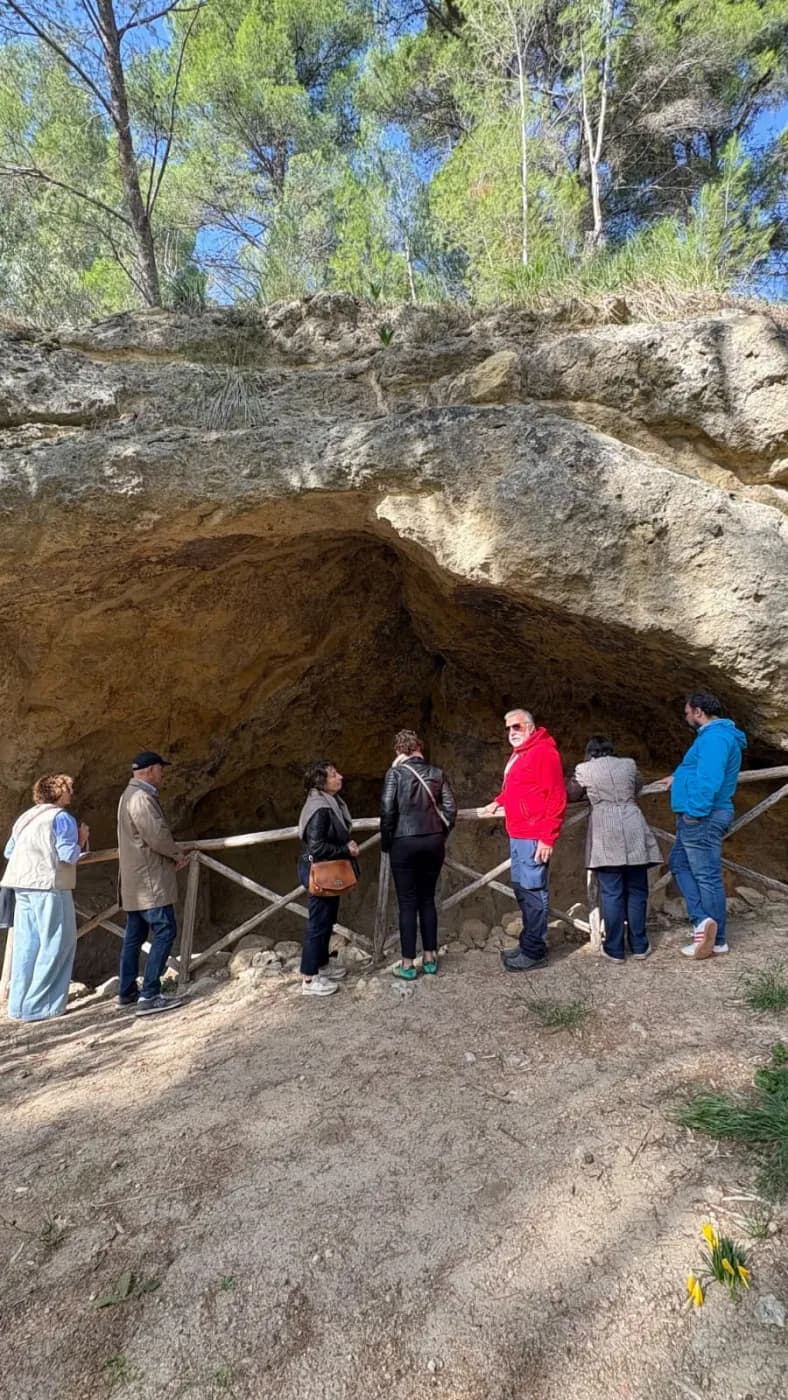 In front of a rock cave